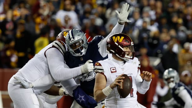 Washington Commanders quarterback Sam Howell (14) is sacked by Dallas Cowboys defensive end Dante Fowler Jr. (56) during the second quarter at FedExField. Mandatory Credit: Geoff Burke-USA TODAY Sports