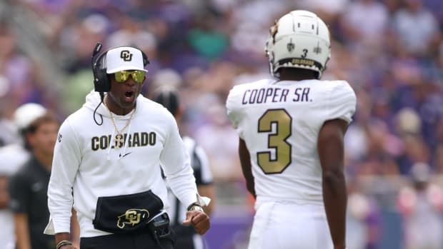 Colorado Buffaloes head coach Deion Sanders yells at cornerback Omarion Cooper.