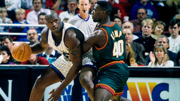 Orlando Magic center Shaquille O'Neal dribbles against Seattle Supersonics center Shawn Kemp.
