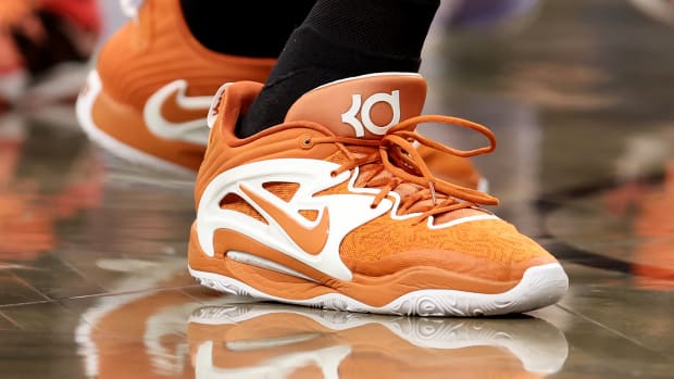 View of Kevin Durant's orange and white Nike shoes.