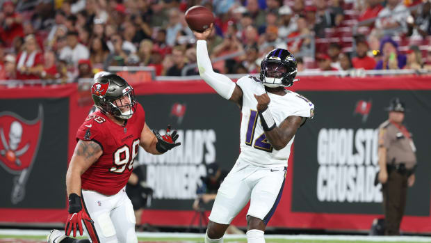 Baltimore Ravens quarterback Anthony Brown (12) throws the ball as Tampa Bay Buccaneers defensive tackle Greg Gaines (96) defends during the second quarter at Raymond James Stadium. Mandatory Credit: Kim Klement Neitzel-USA TODAY Sports