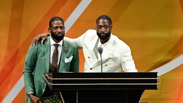 Aug 12, 2023; Springfield, MA, USA; Dwyane Wade (right) calls his father Dwyane Wade Sr. (left) onto the stage at his induction into the 2023 Basketball Hall of Fame at Symphony Hall.