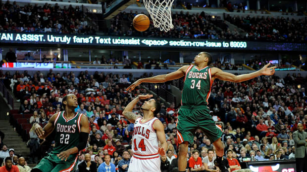 Apr 4, 2014; Chicago, IL, USA; Chicago Bulls guard D.J. Augustin (14) Milwaukee Bucks guard Giannis Antetokounmpo (34) andforward Khris Middleton (22) go for a loose ball during the second half at the United Center.