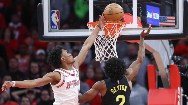 Rockets forward Amen Thompson (1) blocks a shot by Utah Jazz guard Collin Sexton (2) during overtime at Toyota Center.