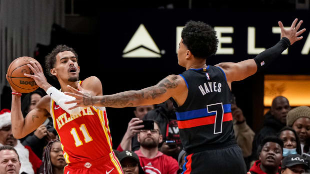 Hawks guard Trae Young looks to pass against Pistons guard Killian Hayes.
