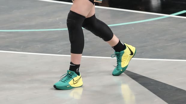 Sabrina Ionescu's green and yellow Nike 'Oregon Ducks' sneakers.