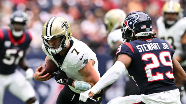 New Orleans Saints quarterback Taysom Hill (7) runs the ball as Houston Texans safety M.J. Stewart (29) defends during the second quarter at NRG Stadium. 