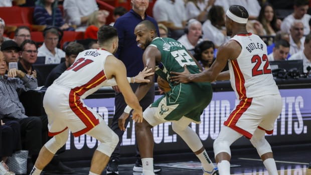 April 22, 2023; Milwaukee Bucks forward Khris Middleton doubled team by Miami Heat's Max Strus and Jimmy Butler during Game 3 of the 2023 NBA Playoffs at Kaseya Center