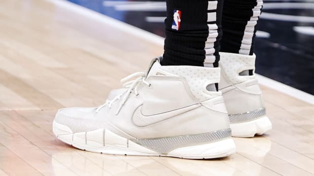 View of white and grey Nike Kobe shoes.