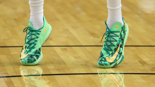 View of green and yellow Nike KD shoes.