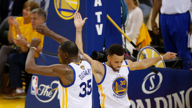 Jun 4, 2017; Oakland, CA, USA; Golden State Warriors guard Stephen Curry (30) celebrates with forward Kevin Durant (35) against the Cleveland Cavaliers during the second half in game two of the 2017 NBA Finals at Oracle Arena.