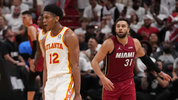 Apr 26, 2022; Miami, Florida, USA; Atlanta Hawks forward De'Andre Hunter (12) reacts after making a three point shot over Miami Heat guard Max Strus (31) during the second half in game five of the first round for the 2022 NBA playoffs at FTX Arena.