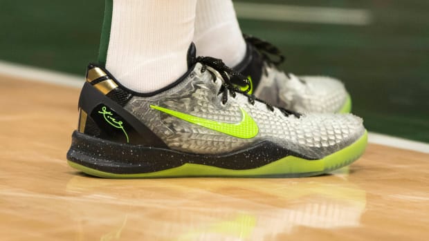 Kobe Bryant's grey and green Nike sneakers.