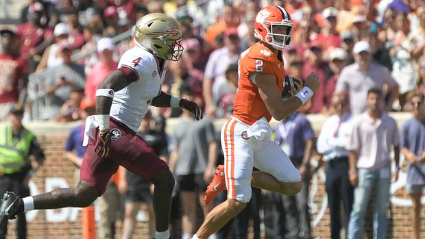 Clemson Tigers quarterback Cade Klubnik (2) runs against Florida State Seminoles linebacker Karen DeLoach (4) during the second quarter at Memorial Stadium.