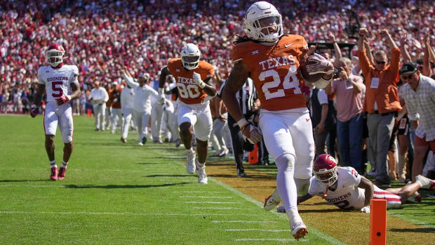 Texas Longhorns running back Jonathon Brooks (24) scores a touchdown late in the fourth quarter against Oklahoma Sooners during an NCAA college football game at the Cotton Bowl on Saturday, Oct. 7, 2023