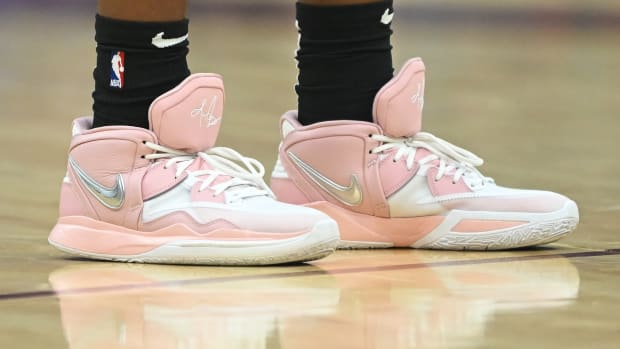 View of pink and white Nike Kyrie shoes.