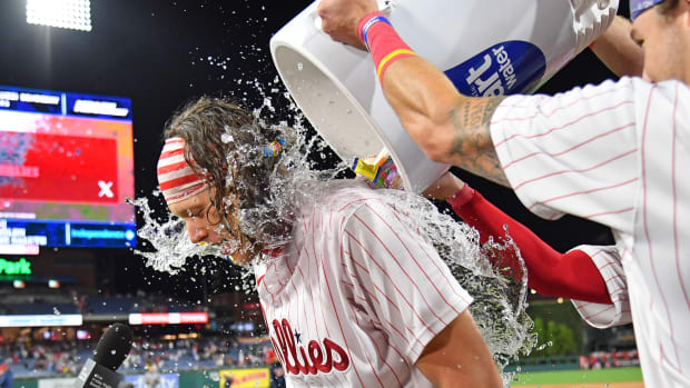 Sep 22, 2023; Philadelphia, Pennsylvania, USA; Philadelphia Phillies first baseman Alec Bohm (28) is doused with water as he celebrates his walk-off single during the tenth inning against the New York Mets at Citizens Bank Park. Mandatory Credit: Eric Hartline-USA TODAY Sports  
