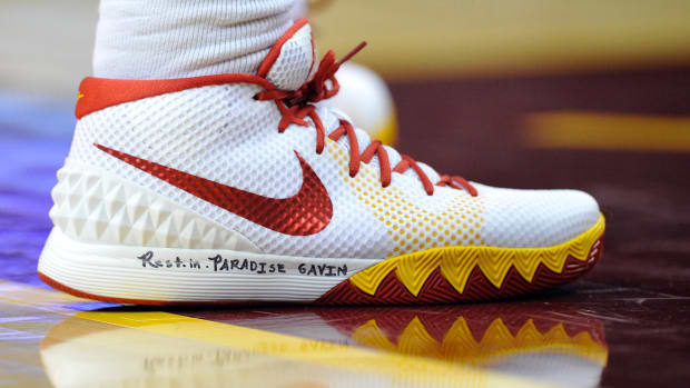 View of white and red Nike Kyrie shoes.