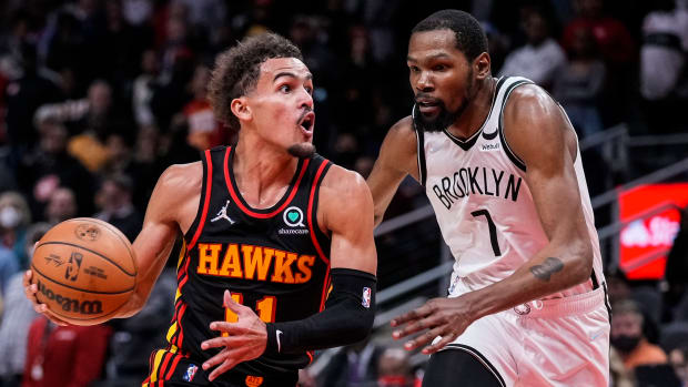 Dec 10, 2021; Atlanta, Georgia, USA; Atlanta Hawks guard Trae Young (11) tries to get to the basket guarded by Brooklyn Nets forward Kevin Durant (7) during the second half at State Farm Arena.