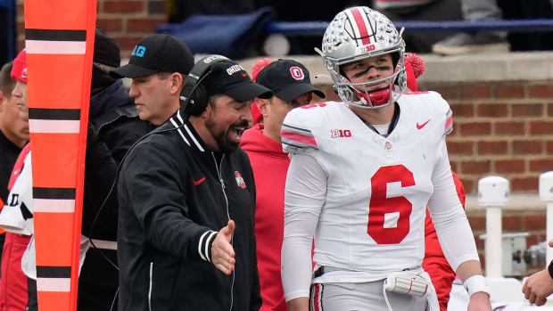 Ohio State QB Kyle McCord takes advice from Buckeyes coach Ryan Day. 