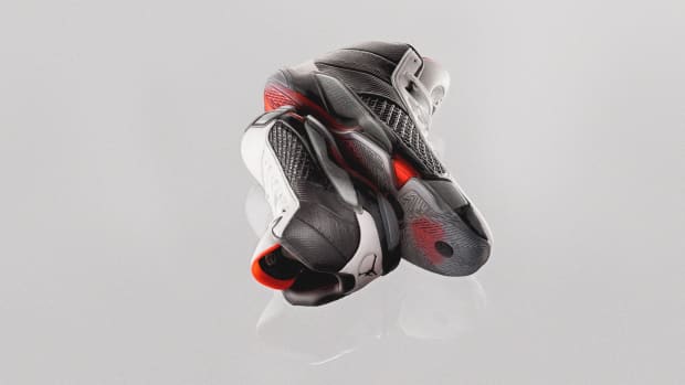 View of stacked black and red Air Jordan basketball shoes.