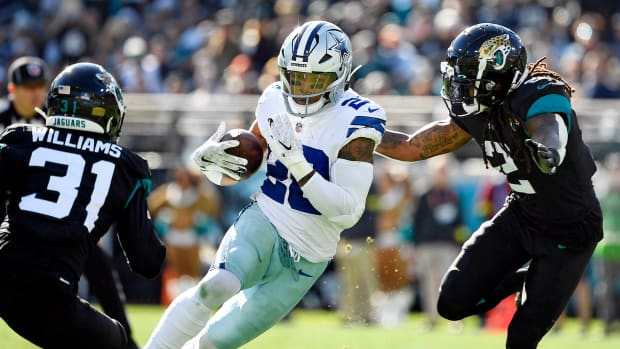 Tony Pollard evades two blockers on a running play for the Dallas Cowboys.