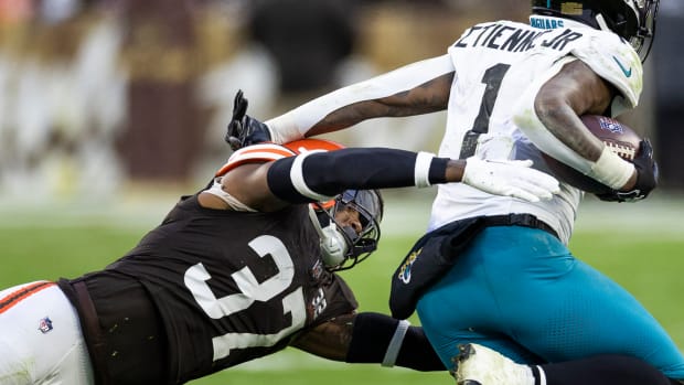 Dec 10, 2023; Cleveland, Ohio, USA; Cleveland Browns safety D'Anthony Bell (37) lunges to tackle Jacksonville Jaguars running back Travis Etienne Jr. (1) during the fourth quarter at Cleveland Browns Stadium. Mandatory Credit: Scott Galvin-USA TODAY Sports
