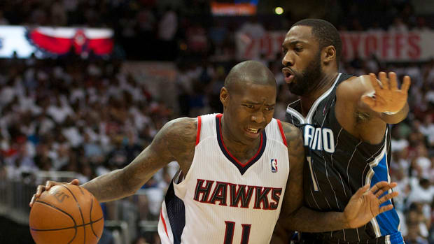Atlanta Hawks guard Jamal Crawford (11) drives the ball past Orlando Magic point guard Gilbert Arenas (1) in the second half of game four of the first round of the NBA playoffs. The Hawks defeated the Magic 88-85.