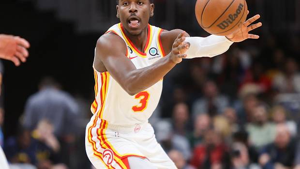 Hawks guard Aaron Holiday passes the ball.