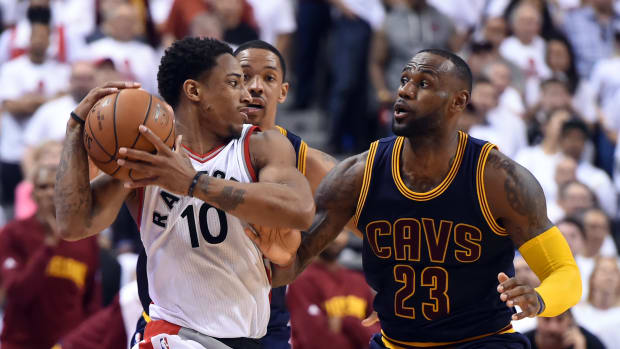 May 23, 2016; Toronto, Ontario, CAN; Toronto Raptors guard DeMar DeRozan (10) holds the ball away from Cleveland Cavaliers forward LeBron James (23) in game four of the Eastern conference finals of the NBA Playoffs at Air Canada Centre.