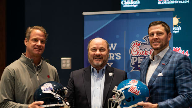 Ole Miss head coach Lane Kiffin (left), athletic director Keith Carter (right) and Peach Bowl CEO and president Gary Stokan.