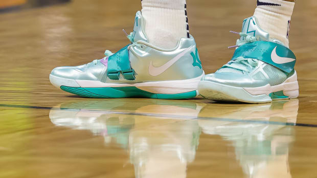 View of teal and white Nike KD shoes.