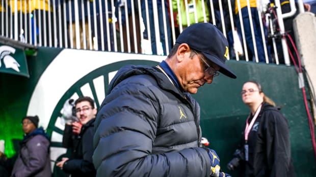 Michigan head coach Jim Harbaugh walks onto the field before the game against Michigan State on Saturday, Oct. 21, 2023, at Spartan Stadium in East Lansing. 