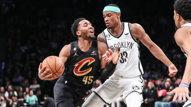 Mar 23, 2023; Brooklyn, New York, USA; Cleveland Cavaliers guard Donovan Mitchell (45) looks to drive past Brooklyn Nets center Nic Claxton (33) in the second quarter at Barclays Center. Mandatory Credit: Wendell Cruz-USA TODAY Sports