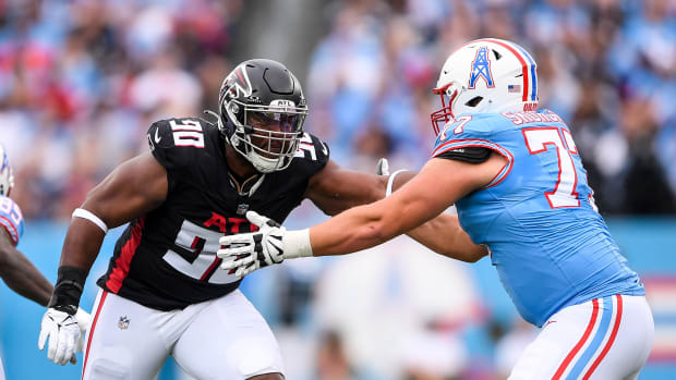 Oct 29, 2023; Nashville, Tennessee, USA; Atlanta Falcons defensive tackle David Onyemata (90) rushes as Tennessee Titans offensive tackle Peter Skoronski (77) defends during the first half at Nissan Stadium. Mandatory Credit: Steve Roberts-USA TODAY Sports