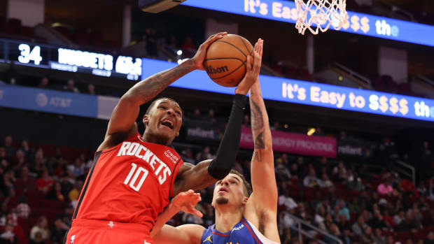 Rockets forward Jabari Smith Jr. scores against Denver Nuggets forward Michael Porter Jr. (1) in the second quarter at Toyota Center.