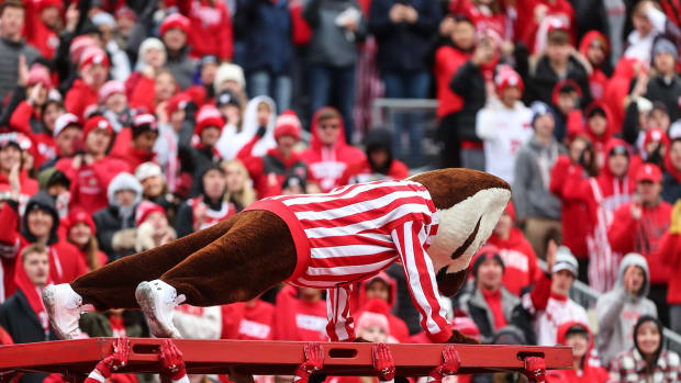 Bucky Badger doing pushups during a Wisconsin football game.