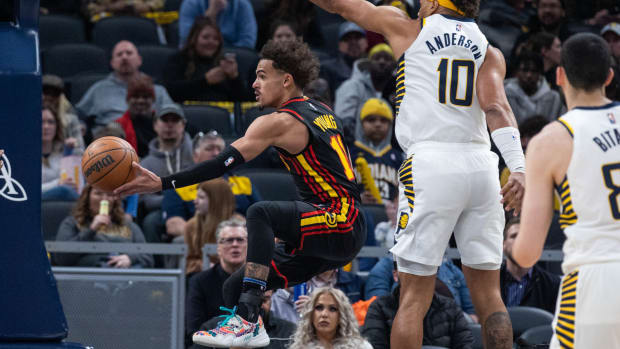 Mar 28, 2022; Indianapolis, Indiana, USA; Atlanta Hawks guard Trae Young (11) passes the ball while Indiana Pacers forward Justin Anderson (10) defends in the second half at Gainbridge Fieldhouse.