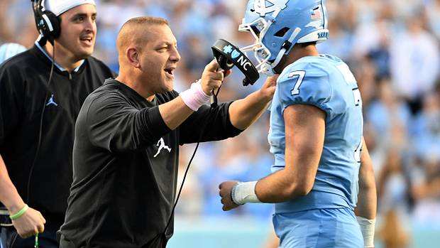 North Carolina offensive coordinator Phil Longo celebrates a big play with Tar Heel quarterback Sam Howell.