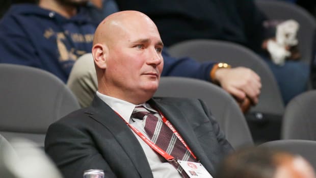 Travis Schlenk watches a game from the stands.