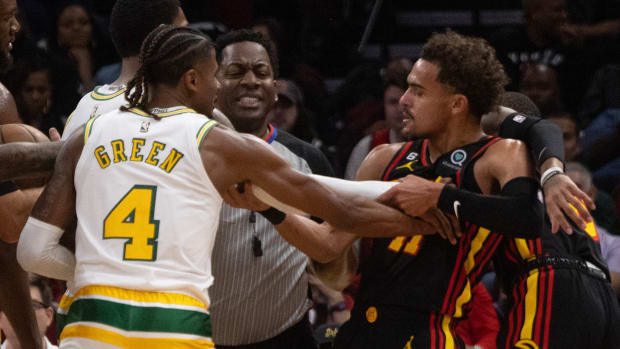 Rockets guard Jalen Green and Hawks guard Trae Young shove each other during a game.