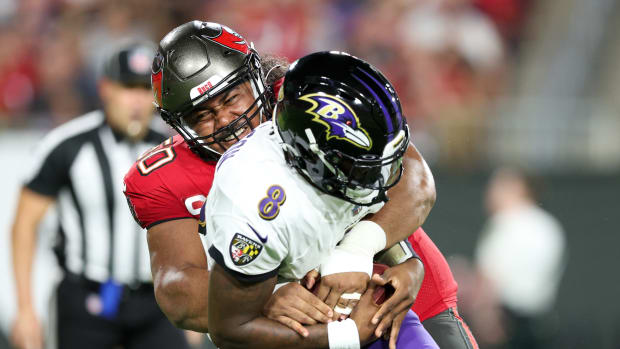 Tampa Bay Buccaneers defensive tackle Vita Vea sacks Baltimore Ravens quarterback Lamar Jackson.
