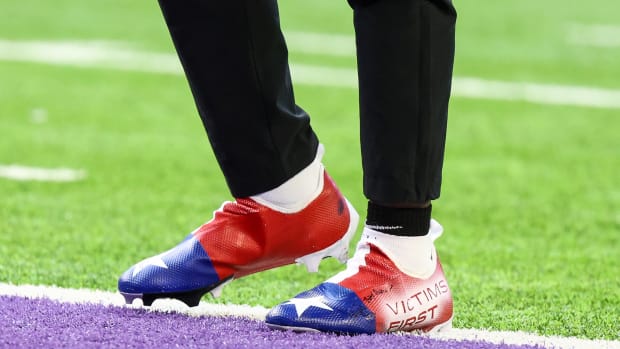 View of red, white, and blue cleats.