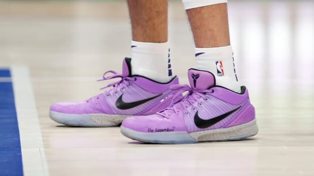 Devin Booker wears a pair of Nike Kobe 4 Protro in a violet colored PE.