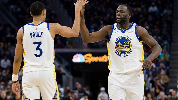 Golden State Warriors guard Jordan Poole (3) and forward Draymond Green (23) celebrate after Poole drew a foul against the Brooklyn Nets during the first half at Chase Center.