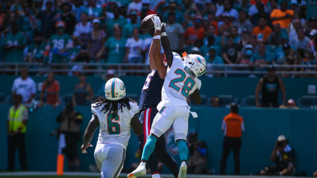 Miami Dolphins cornerback Kader Kohou (28) defends a pass against New England Patriots tight end Hunter Henry.