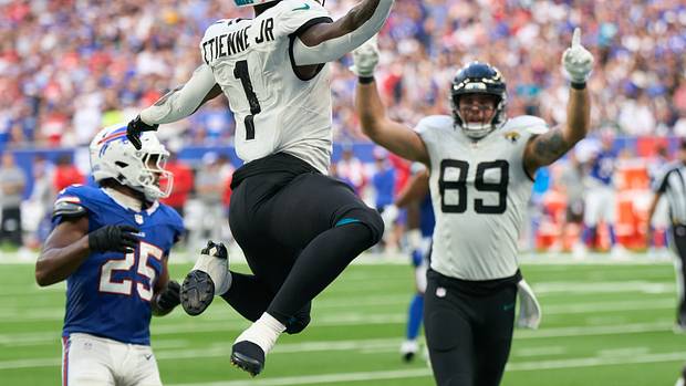 Jacksonville Jaguars running back Travis Etienne Jr. (1) jumps into the end zone for a touchdown during the second half of an NFL International Series game against the Buffalo Bills at Tottenham Hotspur Stadium.