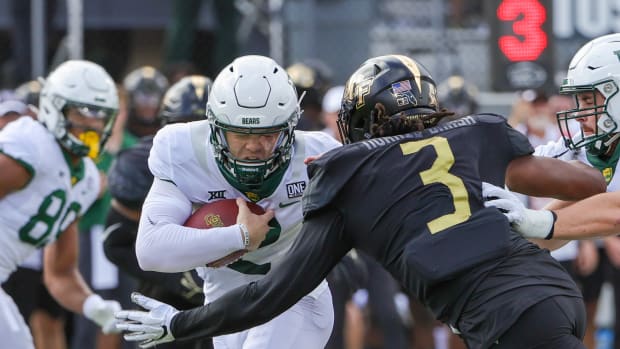 Sep 30, 2023; Orlando, Florida, USA; Baylor Bears quarterback Blake Shapen (12) runs the ball as UCF Knights defensive end Tre'Mon Morris-Brash (3) moves in for the sack during the first quarter at FBC Mortgage Stadium. Mandatory Credit: Mike Watters-USA TODAY Sports