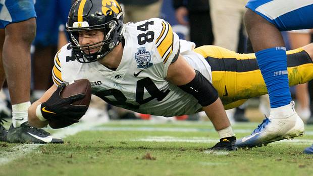 Iowa tight end Sam LaPorta (84) dives for extra yards past Kentucky defenders during the third quarter of the TransPerfect Music City Bowl at Nissan Stadium Saturday,