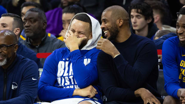 Golden State Warriors guard Stephen Curry (L) and Chris Paul (R) share a laugh during the fourth quarter against the Philadelphia 76ers at Wells Fargo Center. Mandatory Credit: Bill Streicher-USA TODAY Sports